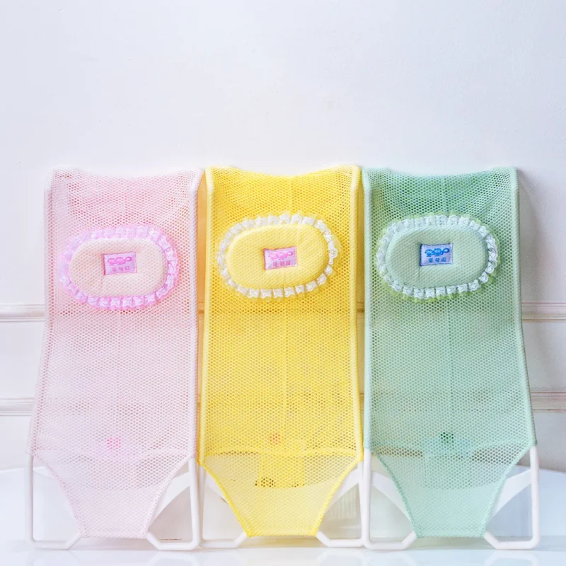 Group shot of three colorful baby bath support net slings (pink, yellow, green) side-by-side.