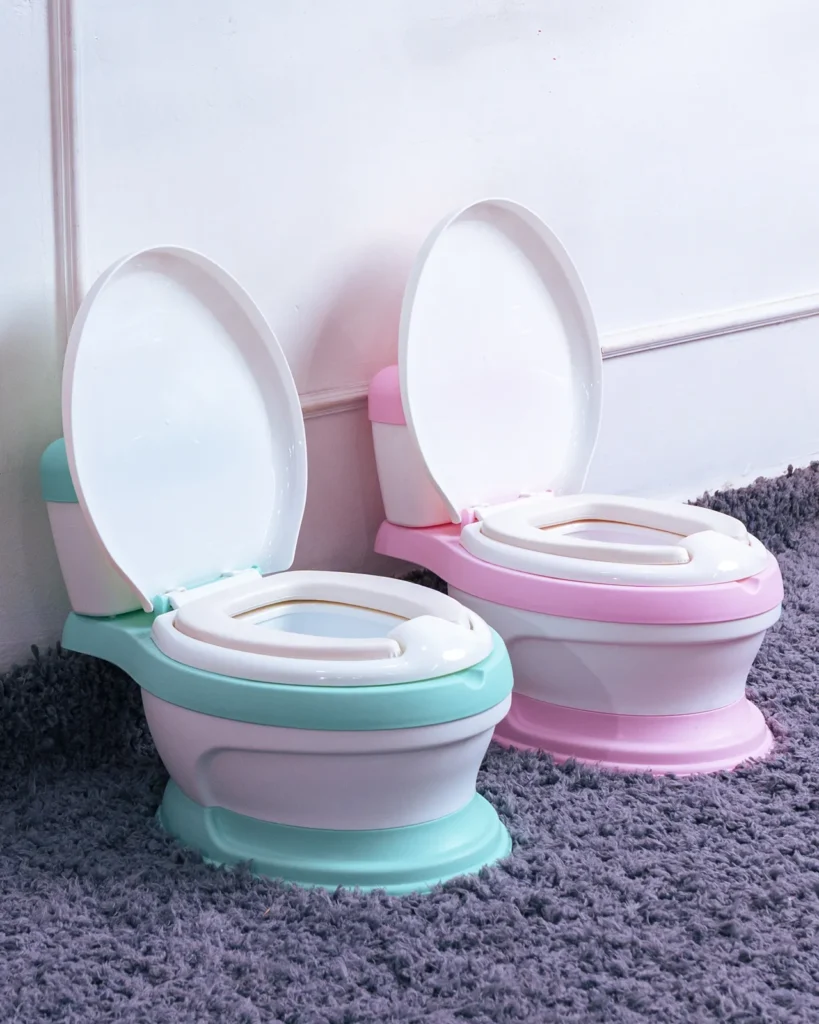 Two realistic potty chairs (pink and teal) sold by Zawadi Baby Shop Nairobi. Durable and safe.