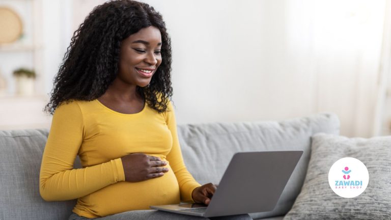 Expectant mother smiling at a laptop, newborn shopping checklist by Zawadi Baby Shop Nairobi.