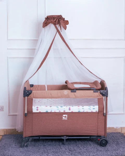 The Co-sleeper With Mosquito Net shown with the detachable changing pad attachment on the side.
