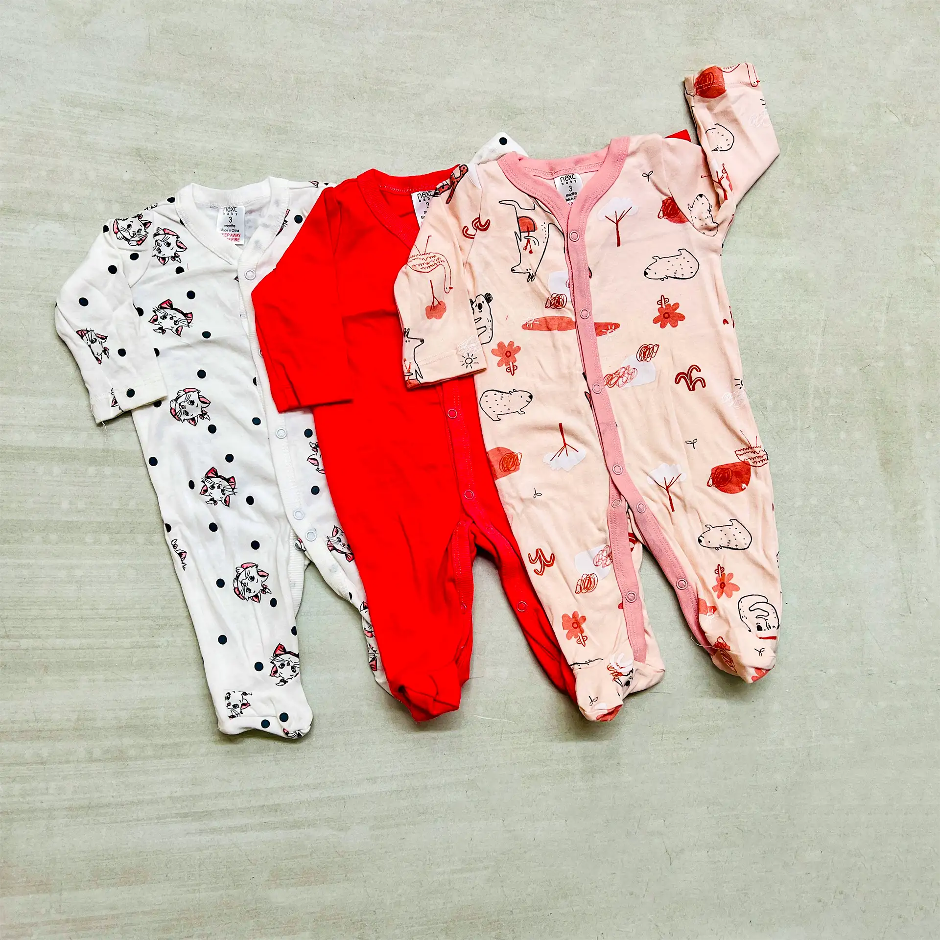 Cotton Rompers 3Pcs Set 7 A Set Of Three Soft Cotton Baby Rompers Featuring White With Animal Prints, Solid Red, And Pink With Nature-Inspired Designs, Perfect For Daily Wear.