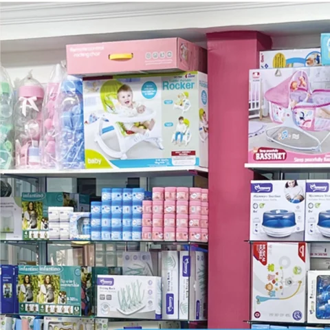 A well-stocked baby store shelf at Zawadi Baby Shop featuring baby rockers, bassinets, feeding accessories, sterilizers, diapers, and other newborn essentials.