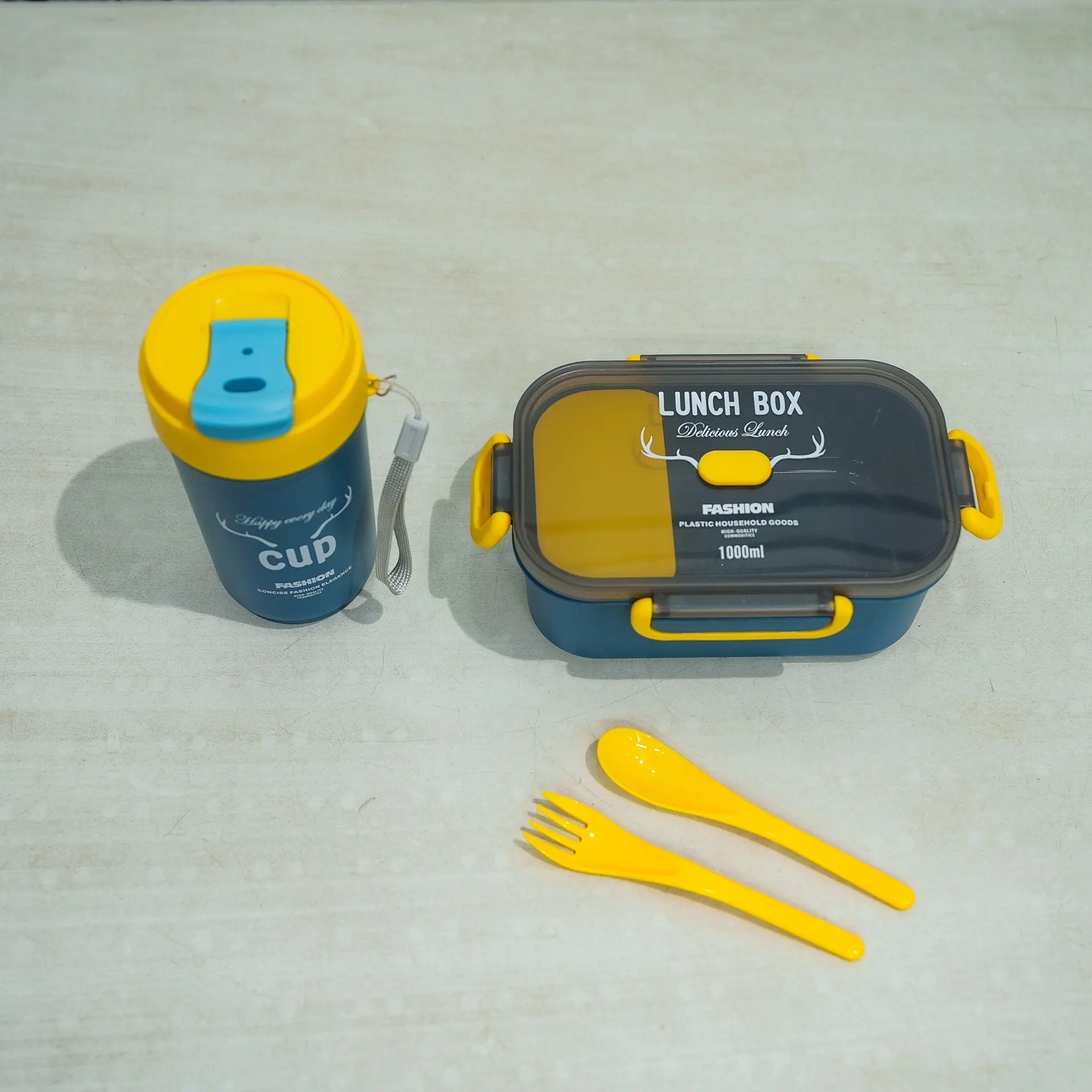 Lunch Box &Amp; Water Bottle Set 9 Yellow-Blue Kids Lunch Set Featuring A Rectangular Lunch Box, A Handled Sippy Cup-Style Water Bottle With A Pink Bear Design (Resembling Lotso From Toy Story) And Pop-Up Straw, And A White Plastic Fork And Spoon With Pattern, Displayed On A Light Surface.
