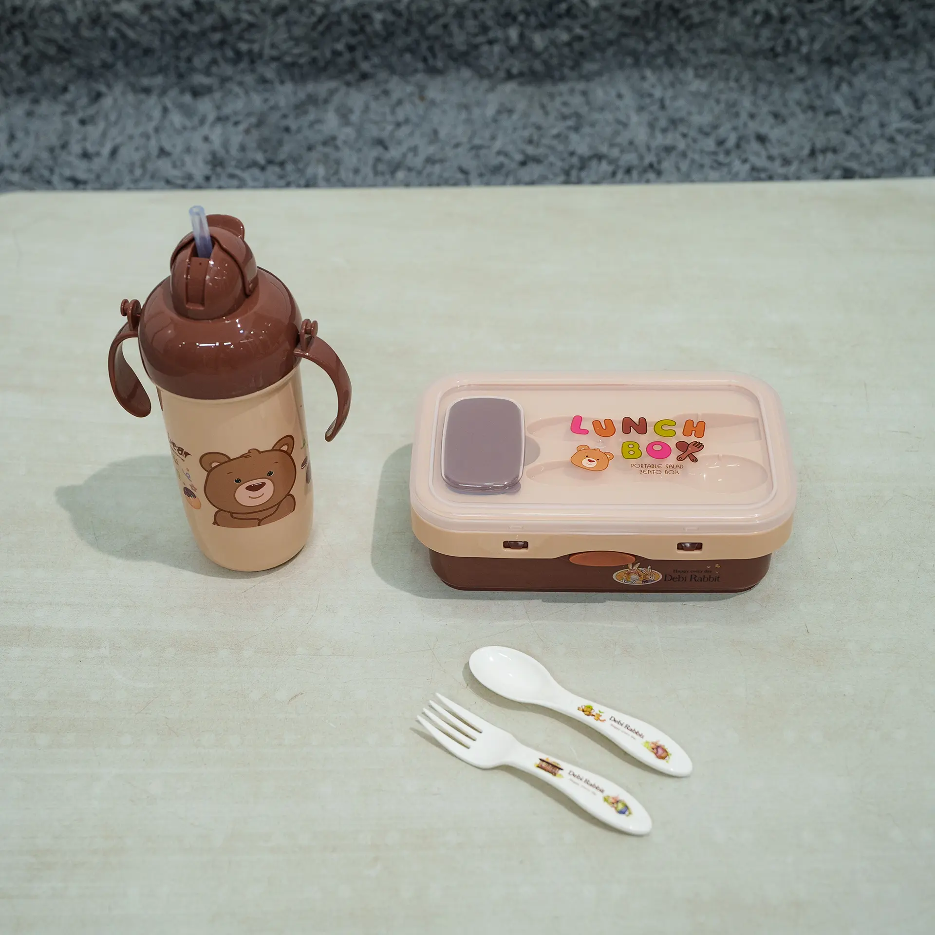Lunch Box &Amp; Water Bottle Set 7 Brown And Beige Kids Lunch Set Featuring A Rectangular Lunch Box, A Handled Sippy Cup-Style Water Bottle With A Pink Bear Design (Resembling Lotso From Toy Story) And Pop-Up Straw, And A White Plastic Fork And Spoon With Pattern, Displayed On A Light Surface.