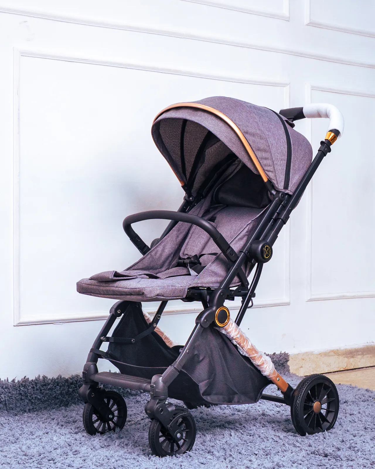 Foldable Baby Stroller For Travel 6 Parent Pushing The Baby Stroller For Travel In A City Setting, Available At Zawadi Baby Shop Nairobi.