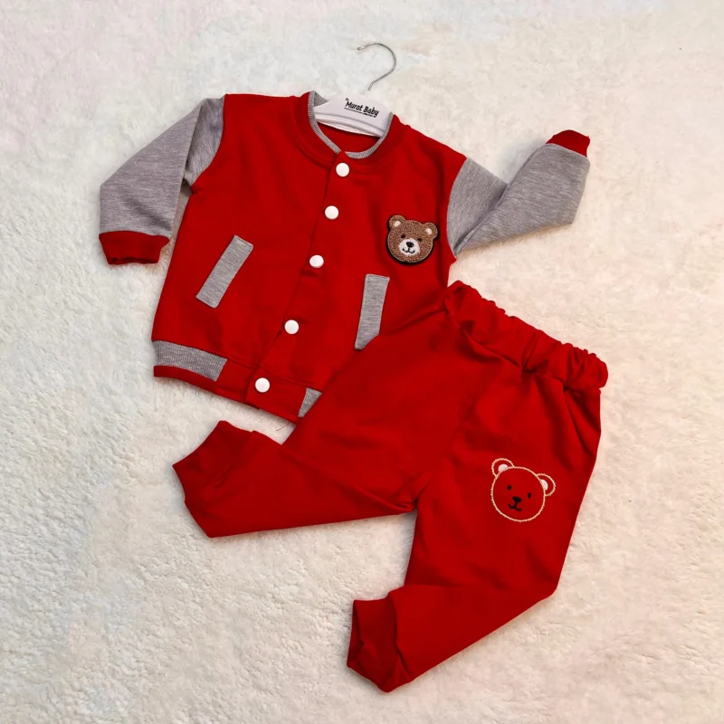 Two-piece baby boy outfit featuring a red varsity-style jacket with grey sleeves, button closure, and bear patch, paired with matching red pants with a bear face design.