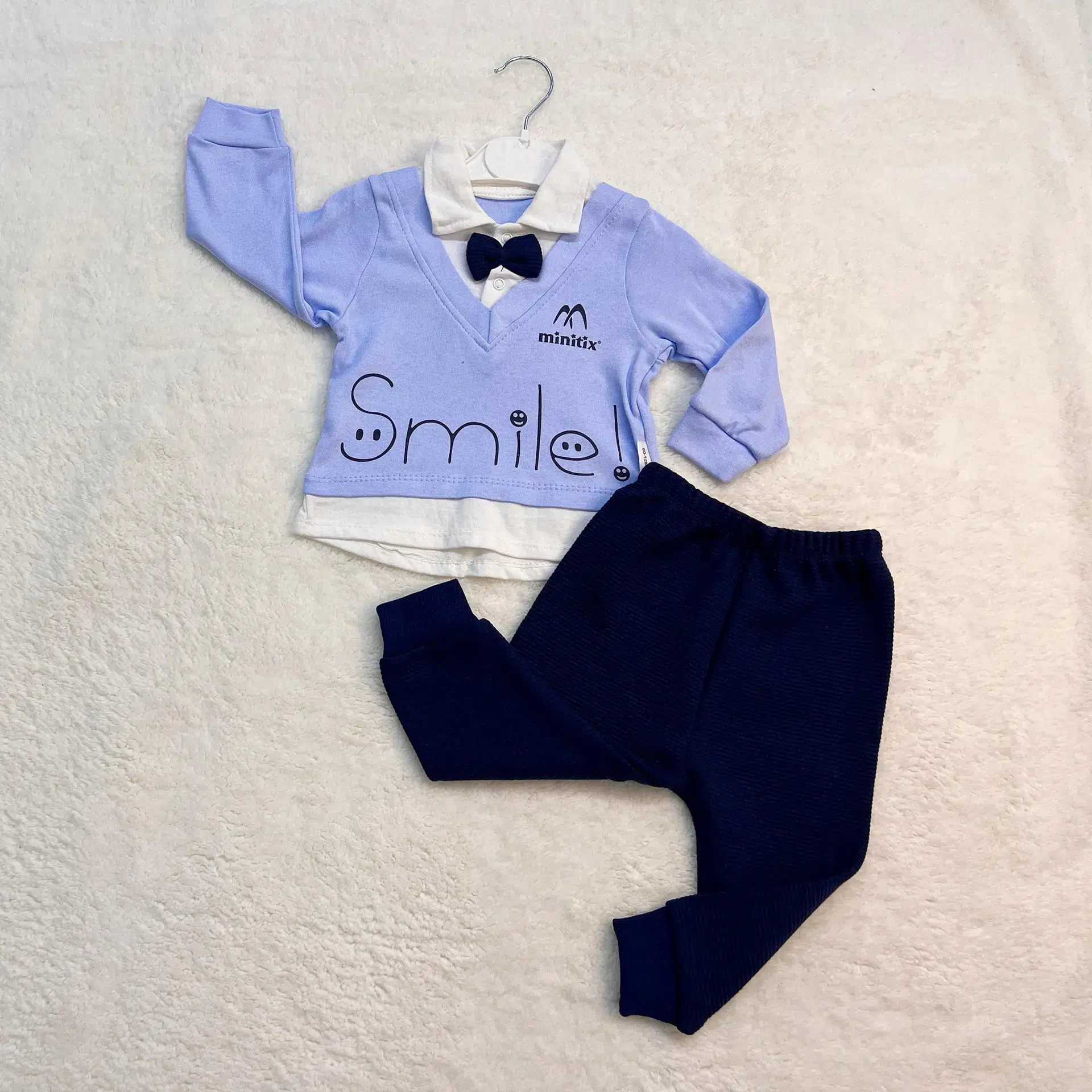 Boys Set 0-12 Months 2 Baby Boy Outfit Set For 0–12 Months Featuring A Light Blue Sweater With A Bowtie And &Quot;Smile&Quot; Print, Paired With Navy Blue Pants.