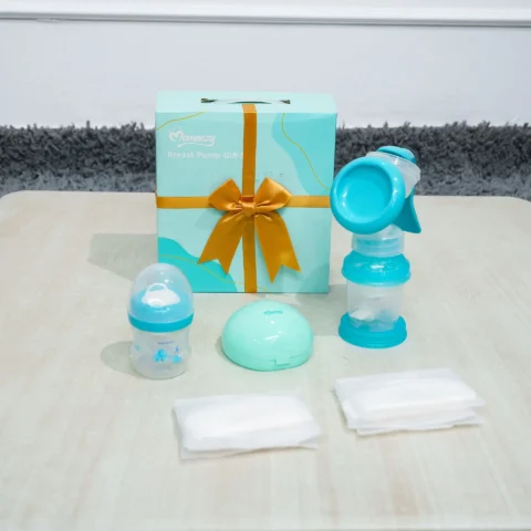 ursing Gift Set with manual breast pump, baby bottle, nursing pads, and storage case displayed in front of a gift box from Zawadi Baby Shop.