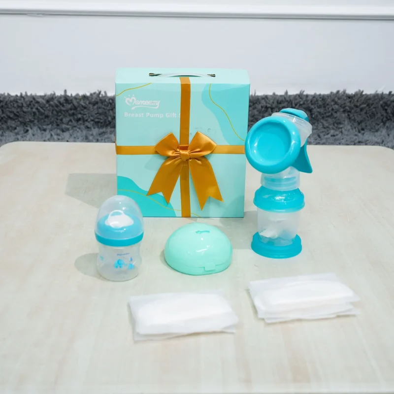 ursing Gift Set with manual breast pump, baby bottle, nursing pads, and storage case displayed in front of a gift box from Zawadi Baby Shop.