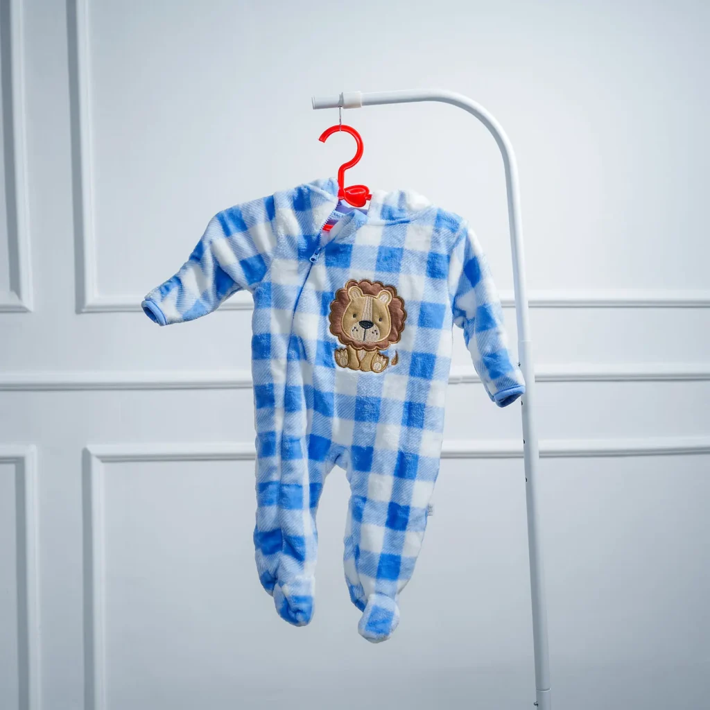 Baby blue and white checkered fleece romper with an embroidered lion design, displayed on a hanger against a white wall.
