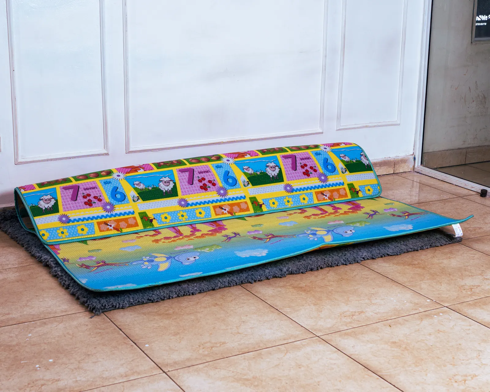 Play Mat Waterproof (1.9 By 2 Metres) 2 Reversible, Large Waterproof Play Mat Showing Sheep And Numbers Pattern, Partially Rolled On A Rug.