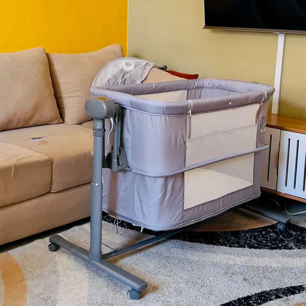 Coolbaby 2 In 1 Electric Bassinet 6 Side View Of The 2 In 1 Electric Bassinet Showing Its Mesh Sides And Wheels, At Zawadi Baby Shop Nairobi.